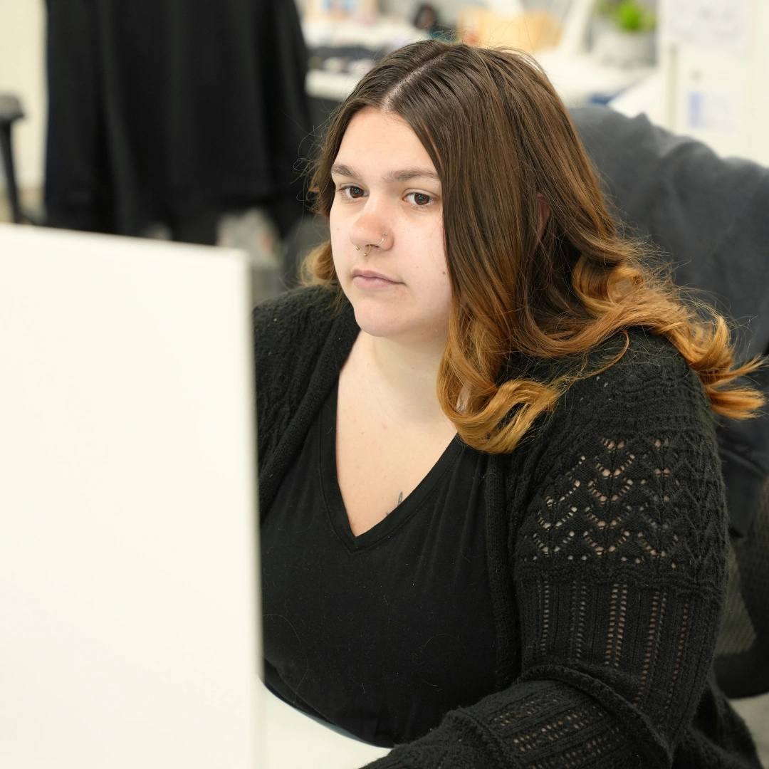 Dedicated Financial GBC team member working on commercial backup servicing on a computer in the office